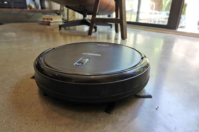 A robotic vacuum-cleaning a polished concrete floor. We recommend robotic vacuums for daily floor maintenance.